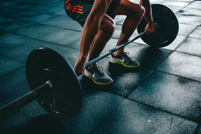Athlete loading a barbell at Peak Performance Gym